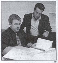 investigators Paul Ciolino, left, and Joe Moura go over the file of Crosley Green